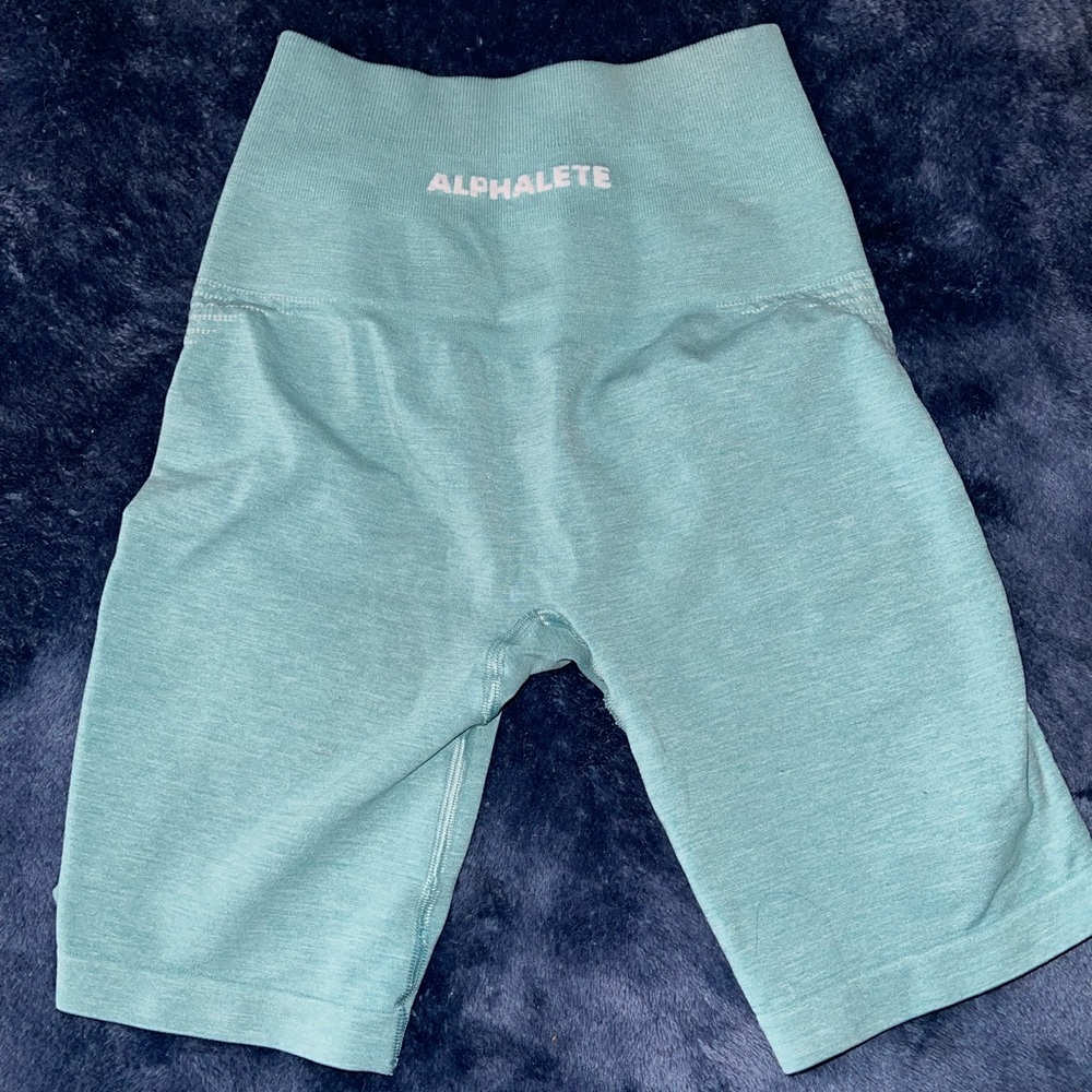 Alphalete biker shorts, size XS, color is light blue/green
